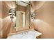 Elegant powder room features a marble countertop, decorative mirror and stylish sconces, enhancing the home's luxurious appeal at 2440 Peachtree Nw Rd # 22, Atlanta, GA 30305