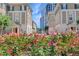 A street view showcases a landscaped median between townhomes with flowering plants at 2440 Peachtree Nw Rd # 22, Atlanta, GA 30305