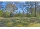 View of a utility shed in the backyard with mature trees providing privacy at 3016 Deshong Dr, Stone Mountain, GA 30087