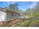 Partial side view of the home, including the screened in porch and backyard at 3016 Deshong Dr, Stone Mountain, GA 30087