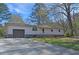 A single-story home features a driveway leading to an integrated garage at 3016 Deshong Dr, Stone Mountain, GA 30087