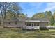 Exterior rear view of the house with screened porch and partially fenced backyard at 3016 Deshong Dr, Stone Mountain, GA 30087