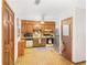 Practical kitchen with wood cabinets, essential appliances, and patterned flooring at 3016 Deshong Dr, Stone Mountain, GA 30087