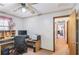 A functional office features a ceiling fan, desk with computer, and easy access to the hallway at 3016 Deshong Dr, Stone Mountain, GA 30087