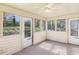 Bright sunroom with multiple windows offering views of the surrounding greenery at 3016 Deshong Dr, Stone Mountain, GA 30087