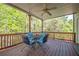 Covered porch featuring outdoor seating and a ceiling fan at 1030 Blankets Creek Dr, Canton, GA 30114