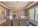 Elegant dining room with chandelier, wainscoting, and ample natural light at 1030 Blankets Creek Dr, Canton, GA 30114