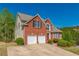 Beautiful brick home featuring a two-car garage and well-maintained landscaping at 1030 Blankets Creek Dr, Canton, GA 30114
