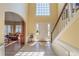 Grand foyer with tile flooring, staircase, and arched doorway to the living room at 1030 Blankets Creek Dr, Canton, GA 30114