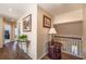 Inviting hallway with hardwood floors, decorative tables, and elegant lighting fixtures at 1030 Blankets Creek Dr, Canton, GA 30114