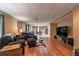 Open-concept living area with hardwood floors, comfortable seating, and seamless transition to dining at 1030 Blankets Creek Dr, Canton, GA 30114
