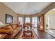 Inviting living room featuring hardwood floors, sofas, and a bright bay window at 1030 Blankets Creek Dr, Canton, GA 30114