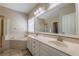 Well-lit main bathroom features double sink vanity, a large mirror, a window, and a soaking tub at 1030 Blankets Creek Dr, Canton, GA 30114