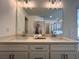 Elegant bathroom vanity with double sinks, quartz countertop, and modern lighting fixtures at 1800 Emory Ln # 98, Conyers, GA 30013