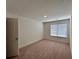 Neutral bedroom with a plush carpet, a window with blinds, and a closet door at 1800 Emory Ln # 98, Conyers, GA 30013