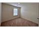 Bright, neutral bedroom featuring carpet floors and a window with horizontal blinds at 1800 Emory Ln # 98, Conyers, GA 30013