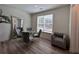 Cozy dining area with modern table and chairs, a decorative mirror, and a patterned accent chair at 1800 Emory Ln # 98, Conyers, GA 30013