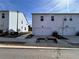 Rear view of townhomes with two-car garages and well maintained landscaping at 1800 Emory Ln # 98, Conyers, GA 30013