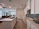 Gourmet kitchen with white cabinetry, an island, and stainless steel appliances open to the living space at 1800 Emory Ln # 98, Conyers, GA 30013