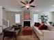 Open living room featuring a fireplace, ceiling fan, and modern decor with access to dining at 1800 Emory Ln # 98, Conyers, GA 30013