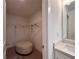 Cozy walk-in closet with neutral-toned carpet and a comfortable ottoman at 1800 Emory Ln # 98, Conyers, GA 30013
