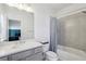 Bright bathroom with a shower-tub combination and a gray vanity at 2384 Provence Park Way, Decatur, GA 30033