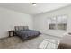 Neutral bedroom with gray carpet, large window, and a bed with a gray comforter at 2384 Provence Park Way, Decatur, GA 30033