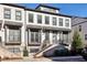 Beautiful townhome with crisp, clean exterior, including a brick facade and inviting entryway staircase at 2384 Provence Park Way, Decatur, GA 30033