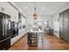 Gourmet kitchen featuring stainless steel appliances, island with bar seating, and stylish pendant lighting fixtures at 2384 Provence Park Way, Decatur, GA 30033