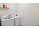 Clean laundry room with a wire shelf above two modern, front-load washing machines at 2384 Provence Park Way, Decatur, GA 30033