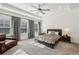 Spacious main bedroom with tray ceiling, three windows, and an elegant ceiling fan at 2384 Provence Park Way, Decatur, GA 30033