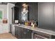 Home bar featuring a marble countertop, dark wood cabinets, and stainless steel appliances for elegant entertaining at 2591 Apple Valley Rd, Brookhaven, GA 30319