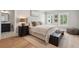 Bedroom with ensuite bathroom featuring a dark wood nightstand, comfy rug, and natural lighting at 2591 Apple Valley Rd, Brookhaven, GA 30319
