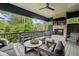 Covered patio space featuring a stone fireplace, outdoor seating, and wooded scenery at 2591 Apple Valley Rd, Brookhaven, GA 30319