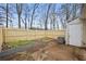 Fenced backyard features planting beds, a concrete patio, and access to the detached storage building at 9023 Stoneleigh Trce, Douglasville, GA 30134