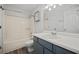 Well-lit bathroom features a tub with shower, a toilet, and modern vanity with white countertop at 9023 Stoneleigh Trce, Douglasville, GA 30134