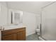 Bathroom with a standup shower, toilet and vanity with a sink, accented by a neutral color scheme at 9023 Stoneleigh Trce, Douglasville, GA 30134