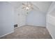 Bonus room features a vaulted ceiling with a ceiling fan, neutral paint, plush carpet, and railing at 9023 Stoneleigh Trce, Douglasville, GA 30134