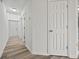 Neutral hallway featuring modern flooring and doors leading to various rooms at 9023 Stoneleigh Trce, Douglasville, GA 30134