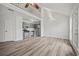 Open living area showcasing modern flooring, gray kitchen, and a loft above at 9023 Stoneleigh Trce, Douglasville, GA 30134