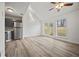 Bright living space with a vaulted ceiling, modern flooring, and sliding glass doors at 9023 Stoneleigh Trce, Douglasville, GA 30134