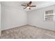 Neutral bedroom featuring ceiling fan, neutral carpeting, and large window at 1661 Paddlewheel Dr, Marietta, GA 30062