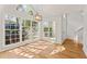 Sunlit dining room with large windows, wood floors, and modern lighting at 1661 Paddlewheel Dr, Marietta, GA 30062