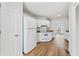 Bright kitchen features white appliances, cabinets, and wood-look flooring at 1661 Paddlewheel Dr, Marietta, GA 30062