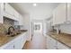 Well-lit kitchen with white cabinets, granite countertops, and a modern backsplash at 1661 Paddlewheel Dr, Marietta, GA 30062