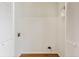 A small and functional laundry room with white walls and hardwood flooring at 1661 Paddlewheel Dr, Marietta, GA 30062