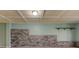 Unfinished basement area with stone accent wall, paneled ceiling, and neutral walls at 189 Meadow Spring Dr, Temple, GA 30179