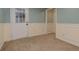 Cozy basement with carpeting, wainscotting, and a door to the outside at 189 Meadow Spring Dr, Temple, GA 30179