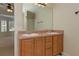 Bathroom features a double sink vanity with wooden cabinets and a large mirror at 189 Meadow Spring Dr, Temple, GA 30179