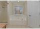 Bathroom features a soaking tub, a large window, and a separate shower at 189 Meadow Spring Dr, Temple, GA 30179